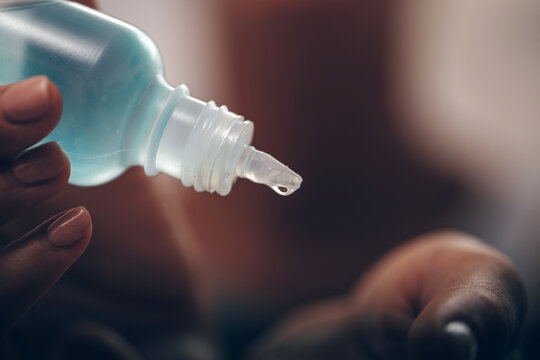 Person Pouring Antiseptic Solution Into His Hand For Hand Cleaning
