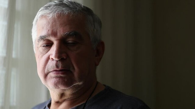 Middle aged man portrait looking at camera. Unshaved senior person