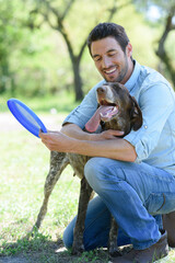 man playing with his dog