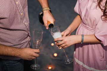 Beautiful young couple with glasses of champagne.