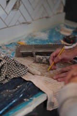 hands of artist doing building work 