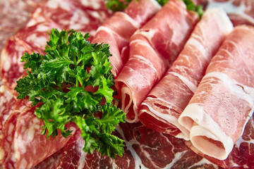 Plate with Assorted different types of smoked sausages, salami and meat