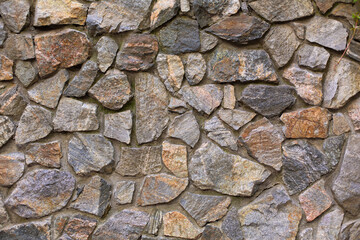 Texture wall made of stones. The wall is made of stones fortified with concrete