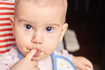 baby holding finger in the mouth the concept of growth of teeth