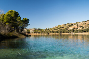 Beautiful lagoon with trees and mountains in the background in the natural park of 'Lagunas de...