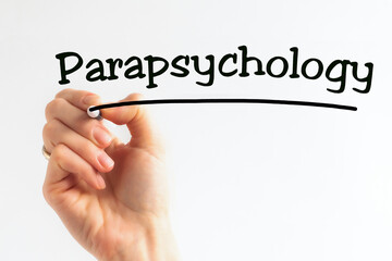 Hand writing inscription Parapsychology with marker, concept