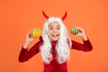 happy girl wear devil horns having long white hair wig holding halloween pumpkin, happy halloween tradition