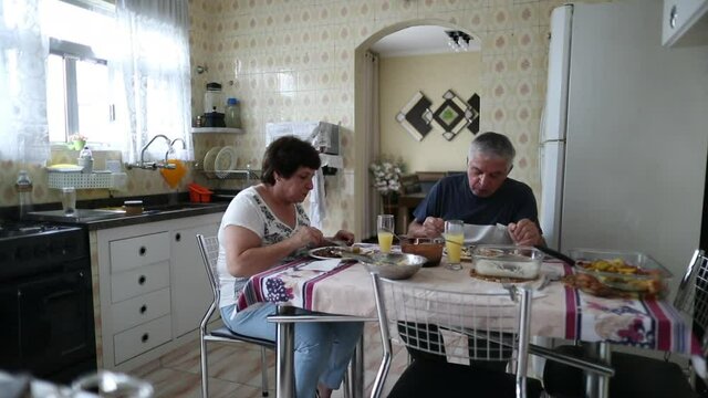 Older couple eating lunch at home. Casual, real people
