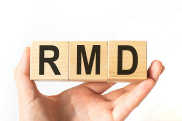 Hand holds wooden cubes with letters rmd. Business concept image.