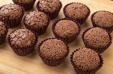 Typical brazilian brigadeiros, various flavors over wooden board