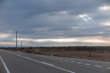 Long road in a flat and dry place between the cities of Burgos and Leon, province of Leon, autonomous community of Castile and Leon, Spain