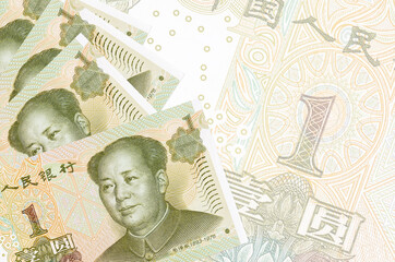 1 Chinese yuan bills lies in stack on background of big semi-transparent banknote. Abstract...