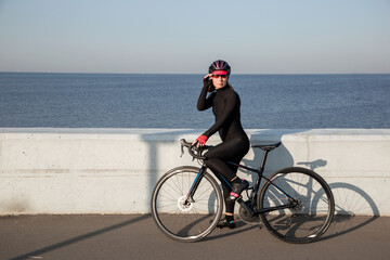 Portrait of female athlete cyclist. Outdoor cycling workout