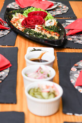 Japanese dinner with sushi, sashimi and shimeji in a boat