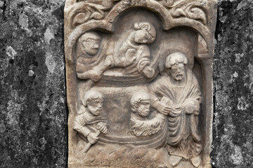 Stone carving depicting Christ and the apostles.  With colour toning and selective colour