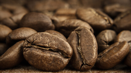 medium roasted coffee beans scattering close-up with soft background and selective focus in foreground. artistic macro photography. front side view