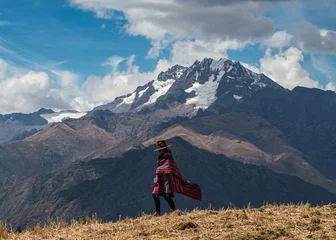 Foto op Canvas A Quechua Woman walks across an Andean ridge near Cusco, Peru © Newman Photo