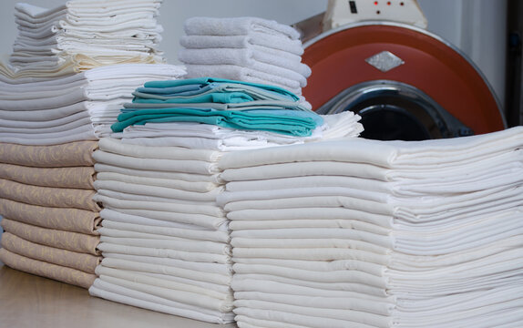 Stack of folded clean cloths in an industrial laundry.