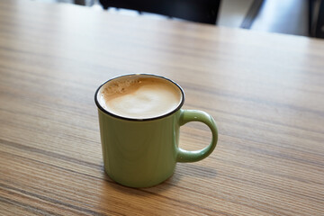 Coffee on a table on a cafe, in tin mug