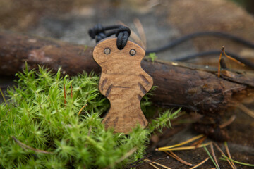 wooden amulet around the neck