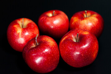 Fresh red apples on a dark background. Juicy natural color of the fruit.
