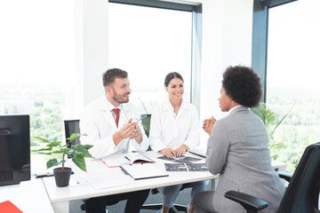 Black woman discussing artificial insemination with doctors