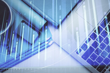Obraz premium Double exposure of forex graph drawing over desktop background with computer. Concept of financial analysis. Top view.