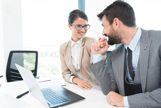 Romantic business couple flirting at office