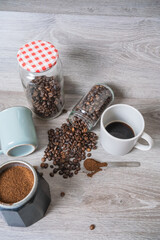 a cup on the table with coffee beans