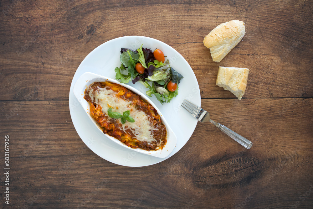 Wall mural a plate of lasagna with a salad