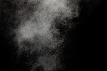 White powder explosion cloud against black background.White dust particles splash.