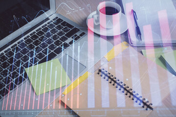 Multi exposure of forex graph drawing and desktop with coffee and items on table background. Concept of financial market trading