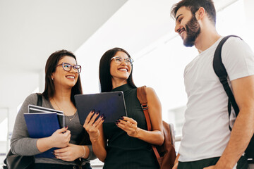 Group of college students talking in corridor