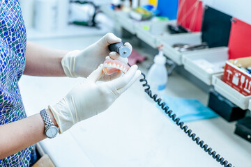Prosthetics hands while working on the denture