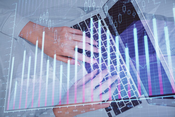Double exposure of woman hands working on computer and forex chart hologram drawing. Top View. Financial analysis concept.