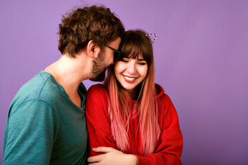 Carefree blithesome young hipster couple hugs and smiling, romantic mood, love and family, close up studio portrait of happy woman and handsome bearded man, casual clothes, positive mood.