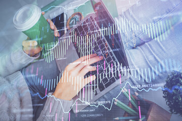 Double exposure of woman hands typing on computer and forex chart hologram drawing. Stock market invest concept.