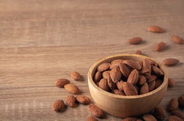 Almond in wooden bowl on table