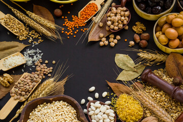 Designed a harvest frame on black surface with natural,dried foods.Blank space for text on center of image.
