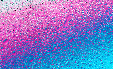 water drops on a glass...

Lilac-blue diagonal background with fine splashes of water, close-up side view.