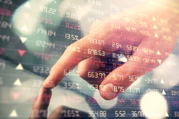 Fototapeta premium Multi exposure of man's hands holding and using a phone and financial chart drawing. Market analysis concept.