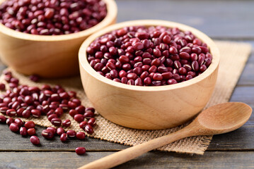Azuki beans or red mung beans in a bowl and spoon on wooden table