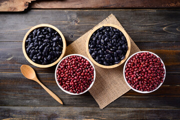 Black kidney beans and azuki beans in a bowl on wooden background, Top view