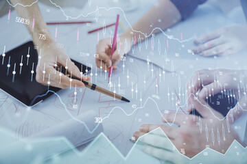 Double exposure of forex graph drawing and man and woman working together holding and using a mobile device. Trade concept.