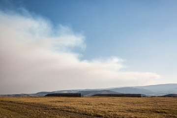 Landscape view of the forest fire smoke growing over the plains of Wyoming