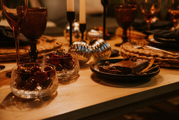 Christmas table with candles, glasses and decorations