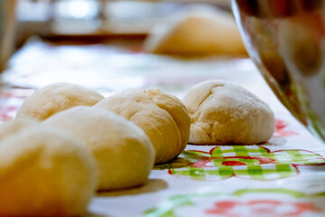 raw balls of bread in the kitchen table