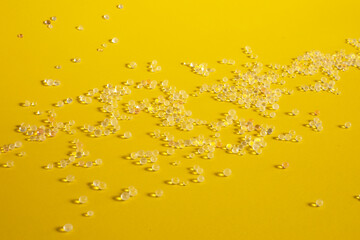 Silica gel spread on a yellow background, Desiccant used in industrial, moisture protection