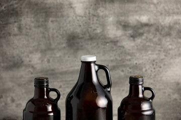 beer growler bottles for craft beer with white space for a copy over a grey background