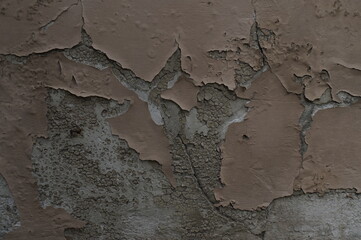 Photo of the destroyed surface of the exterior wall. Cracks, plaster failures, paint scuffs. In...